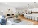 Bright open-concept living room boasts contemporary decor, hardwood floors, and a seamless flow to the kitchen at 5404 Maplewood Ln, Charlotte, NC 28227
