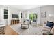Bright living room featuring a stylish rug, neutral furniture, and sliding glass doors to bring the outdoors in at 5404 Maplewood Ln, Charlotte, NC 28227