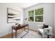 Bright office space with a modern desk, comfortable seating, and a large window with a view at 5404 Maplewood Ln, Charlotte, NC 28227
