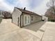 View of the home's exterior, showcasing the clean siding and modern windows and large patio at 5610 Stone Bluff Ct, Charlotte, NC 28214