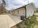 View of the home's exterior, showcasing the clean siding, modern windows and patio at 5610 Stone Bluff Ct, Charlotte, NC 28214