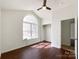 Bright bedroom featuring a ceiling fan, vaulted ceiling and large window at 5610 Stone Bluff Ct, Charlotte, NC 28214