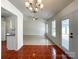 Bright dining area with chandelier, tile floors, access to the kitchen and backyard at 5610 Stone Bluff Ct, Charlotte, NC 28214