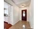 Welcoming entryway featuring tile flooring, a dark wood front door and access to kitchen at 5610 Stone Bluff Ct, Charlotte, NC 28214