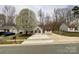 Charming single-story home featuring a large driveway and blooming trees in front yard at 5610 Stone Bluff Ct, Charlotte, NC 28214