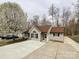 Charming single-story home with a well-manicured lawn and extended driveway at 5610 Stone Bluff Ct, Charlotte, NC 28214
