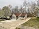 Charming home with a well-manicured lawn, mature trees, and a concrete driveway at 5610 Stone Bluff Ct, Charlotte, NC 28214