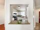 Bright kitchen with white cabinetry, stainless appliances, and granite countertops view through open wall at 5610 Stone Bluff Ct, Charlotte, NC 28214