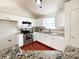 Well-lit kitchen features bright cabinetry, stainless steel appliances, granite counters, and mosaic backsplash at 5610 Stone Bluff Ct, Charlotte, NC 28214