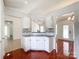 Open kitchen view featuring bright cabinetry, mosaic backsplash, and granite countertop at 5610 Stone Bluff Ct, Charlotte, NC 28214