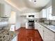 Bright eat-in kitchen featuring white cabinets, stainless steel appliances, and granite countertops at 5610 Stone Bluff Ct, Charlotte, NC 28214