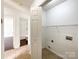 Hallway view featuring laundry room with a wire rack and washer/dryer hookups at 5610 Stone Bluff Ct, Charlotte, NC 28214