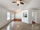 Open-concept living area with tile floors, ceiling fan, chandelier, and bright airy feel at 5610 Stone Bluff Ct, Charlotte, NC 28214