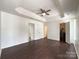 Large primary bedroom boasts tray ceilings, ceiling fan, and multiple closets at 5610 Stone Bluff Ct, Charlotte, NC 28214
