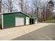 View of the property's two storage buildings and concrete slab at 5610 Stone Bluff Ct, Charlotte, NC 28214