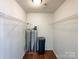 Walk-in closet featuring water tanks and wire shelving at 5610 Stone Bluff Ct, Charlotte, NC 28214
