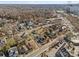 An aerial view of a neighborhood showcasing a variety of homes, tree-lined streets, and nearby commercial areas at 701 S Torrence St, Charlotte, NC 28204