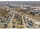 Aerial view of the property showcasing the surrounding neighborhood and city landscape with many buildings and houses at 701 S Torrence St, Charlotte, NC 28204