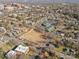 Neighborhood aerial view showing an elementary school, playground, and residential houses in a tree-filled community at 701 S Torrence St, Charlotte, NC 28204