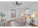 Relaxing bedroom featuring neutral tones, hardwood floors, a decorative ceiling fan, and ambient lighting at 701 S Torrence St, Charlotte, NC 28204
