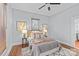 Bedroom showcasing hardwood floors, neutral tones, natural light, and a ceiling fan for added comfort at 701 S Torrence St, Charlotte, NC 28204