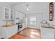 Bright kitchen with white cabinets, stainless steel appliances, wood countertops, and natural light at 701 S Torrence St, Charlotte, NC 28204