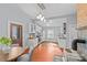 Open kitchen with white cabinets, breakfast table, stainless steel appliances, and wood flooring at 701 S Torrence St, Charlotte, NC 28204