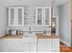 Kitchen with butcher block countertops, subway tile backsplash, white cabinets, and stainless microwave at 701 S Torrence St, Charlotte, NC 28204