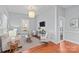 Well-lit living room boasts hardwood floors, neutral color palette, and open layout leading to other rooms at 701 S Torrence St, Charlotte, NC 28204