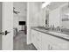 Bathroom featuring a double sink vanity with gray countertops, white cabinets, and a view into the bedroom at 894 Abilene Ln, Fort Mill, SC 29715
