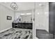 Bathroom featuring double sinks, a walk-in shower with black herringbone tiles and a modern chandelier at 894 Abilene Ln, Fort Mill, SC 29715