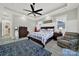 Spacious bedroom with a ceiling fan, accent chair, and bedside tables at 894 Abilene Ln, Fort Mill, SC 29715