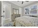 Bedroom featuring a window, closet, light gray walls, and a dresser with a large mirror for getting ready at 894 Abilene Ln, Fort Mill, SC 29715