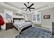 Bright bedroom featuring a tray ceiling, ceiling fan, and a blue patterned rug at 894 Abilene Ln, Fort Mill, SC 29715