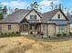 Charming brick home with a covered entry, beautiful landscaping, and an inviting facade at 894 Abilene Ln, Fort Mill, SC 29715