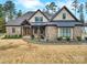 Inviting brick home featuring a covered front porch, manicured landscaping, and a charming, traditional design at 894 Abilene Ln, Fort Mill, SC 29715