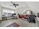 Spacious living area with a ceiling fan, gray plank flooring, and comfortable leather furniture at 894 Abilene Ln, Fort Mill, SC 29715