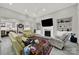 Spacious living room featuring a cozy fireplace, built-in shelving, and comfortable seating at 894 Abilene Ln, Fort Mill, SC 29715