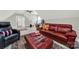 Bright living space featuring a workspace, with leather sofas, plank floors, and unique ceiling architecture at 894 Abilene Ln, Fort Mill, SC 29715