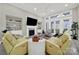 Inviting living room with a fireplace, ceiling fan, and abundant natural light from large windows at 894 Abilene Ln, Fort Mill, SC 29715