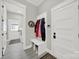 Mud room entry with coat hooks, bench, and access to the laundry room and front door at 894 Abilene Ln, Fort Mill, SC 29715