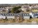 Aerial view of condo complex with manicured landscaping, trees, and parking areas, showcasing community layout at 1068 Plaza Walk Dr, Charlotte, NC 28215