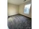 Bedroom with a window and gray carpet at 1068 Plaza Walk Dr, Charlotte, NC 28215
