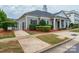 Exterior view of the well-maintained clubhouse with manicured landscaping and classic architectural details at 1068 Plaza Walk Dr, Charlotte, NC 28215
