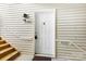 Condo entrance featuring a white front door with sidelight panels, complemented by stairs and siding at 1068 Plaza Walk Dr, Charlotte, NC 28215