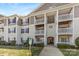 Multi-story condo building featuring private balconies, well-kept grounds and accessible parking at 1068 Plaza Walk Dr, Charlotte, NC 28215