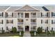 Close up on a multi-story condo building featuring private balconies, well-kept grounds and accessible parking at 1068 Plaza Walk Dr, Charlotte, NC 28215