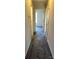 View of carpeted hallway with multiple doors and a window in the distance at 1068 Plaza Walk Dr, Charlotte, NC 28215