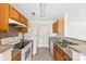 Well-lit kitchen featuring wood cabinets, neutral countertops and appliances at 1068 Plaza Walk Dr, Charlotte, NC 28215