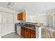 Efficient kitchen featuring wooden cabinets and an adjacent living space at 1068 Plaza Walk Dr, Charlotte, NC 28215